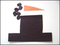3. Découpez un nez dans le papier orange ainsi qu’un chapeau et de petits ronds de charbon dans le papier noir.